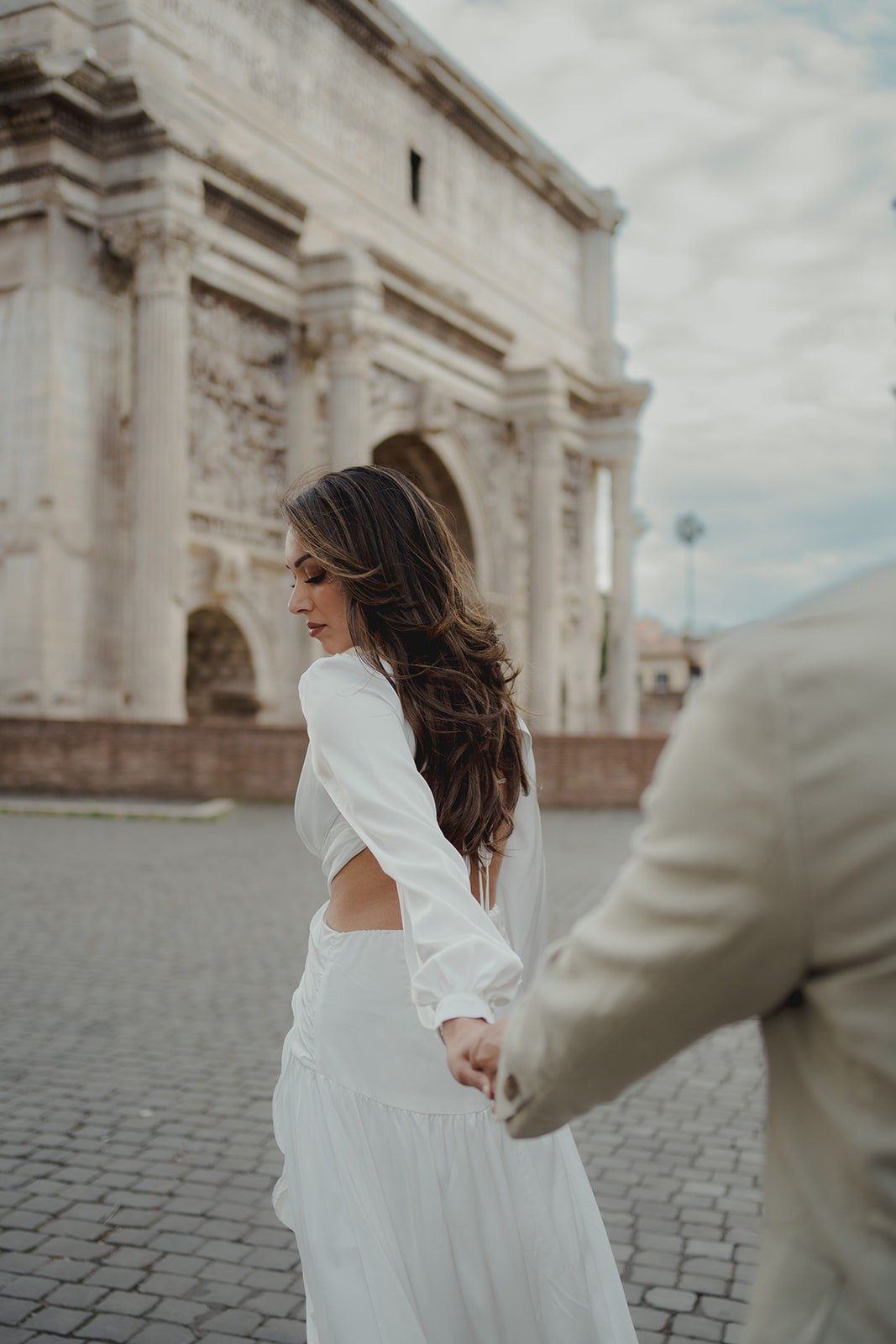 Bride walking through historic streets of Rome during an intimate elopement