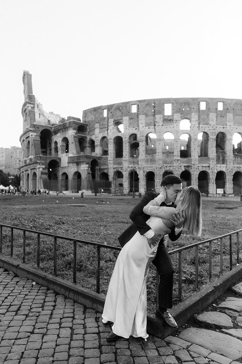 Couple kissing during a romantic elopement at the Colosseum in Rome Italy
