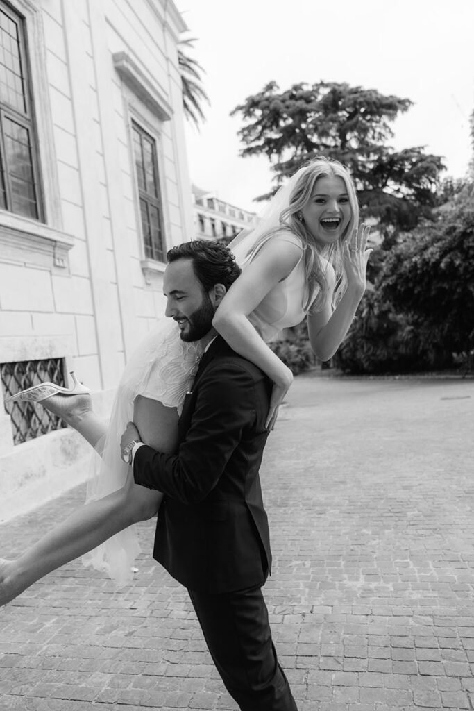 Groom lifting his bride in joy outside a Roman villa – playful and authentic moment from an elopement in Rome