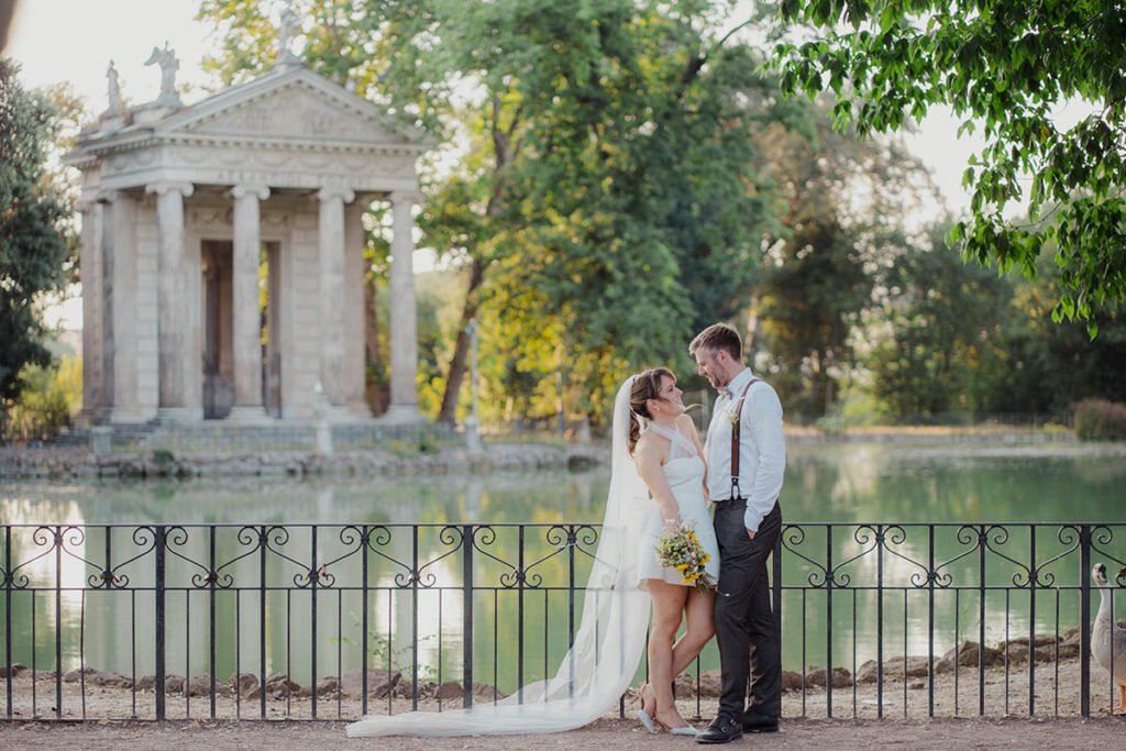 Bride and groom standing near Temple of Asclepius in Villa Borghese.
