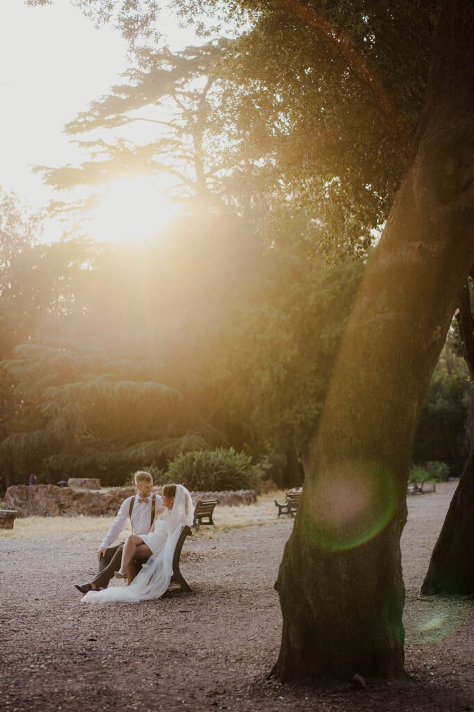 Elopement portrait of the couple with the light shining through the trees