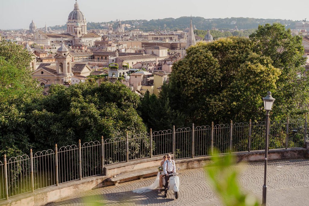 Couple riding a vintage white Vespa through a scenic Roman street.