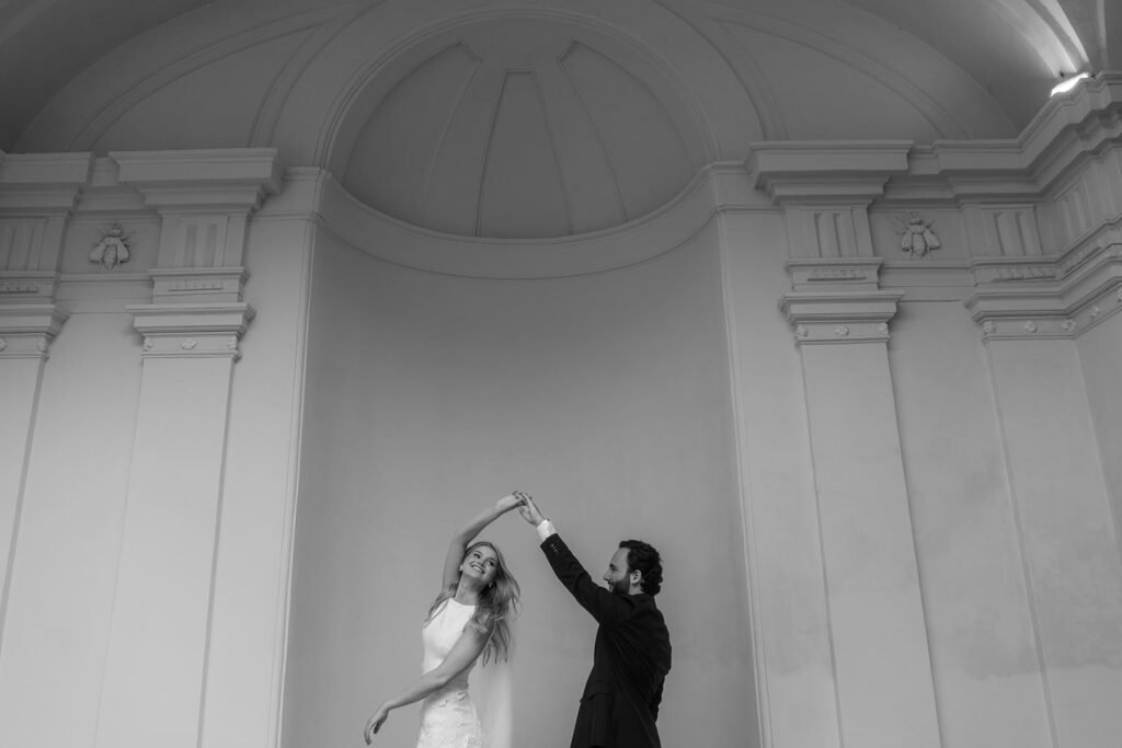 Bride and groom dancing under a domed Roman structure – timeless moment from a Rome elopement