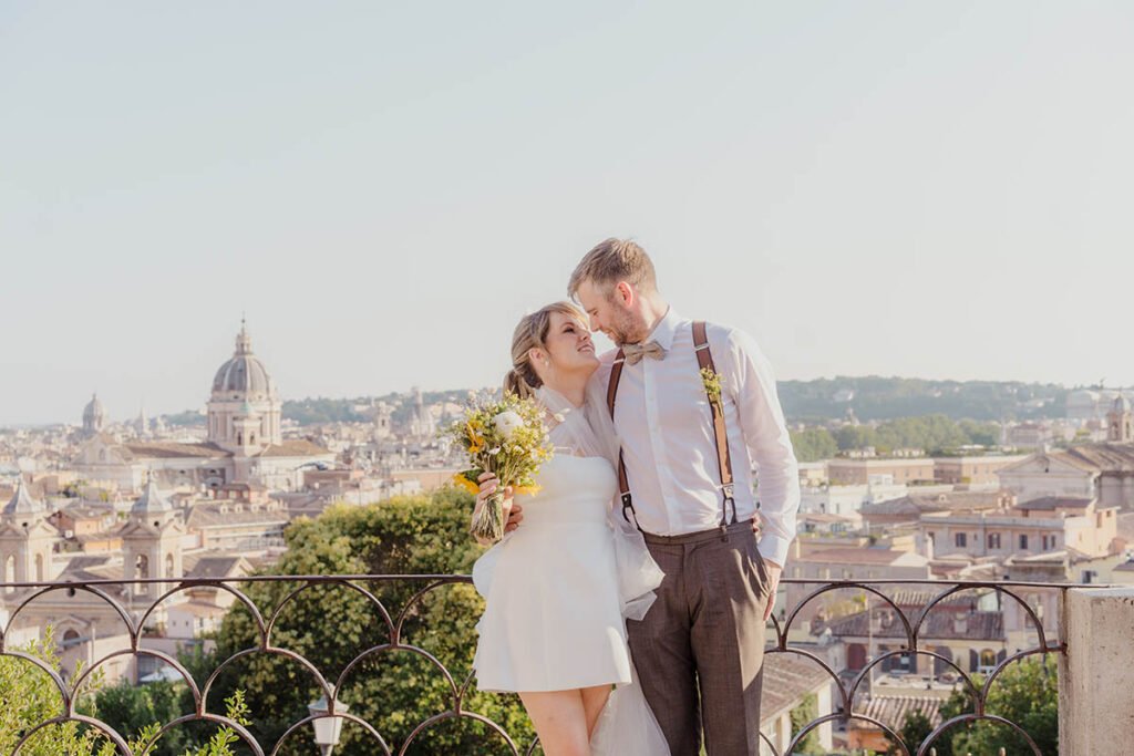 Bride resting her head on the groom’s shoulder with city view behind.