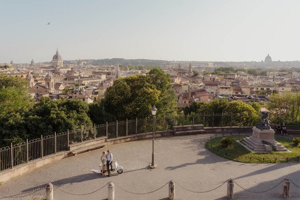 Couple on Vespa near a panoramic terrace in Rome.