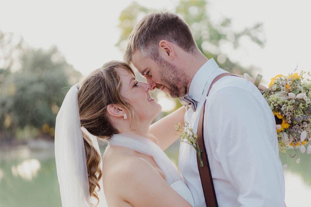 Bride and groom with foreheads touching and Rome in the background.