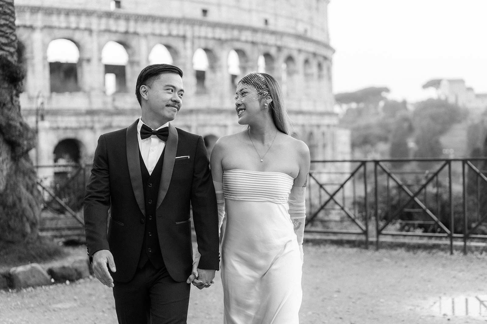 Rome elopement couple smiling in front of the Colosseum