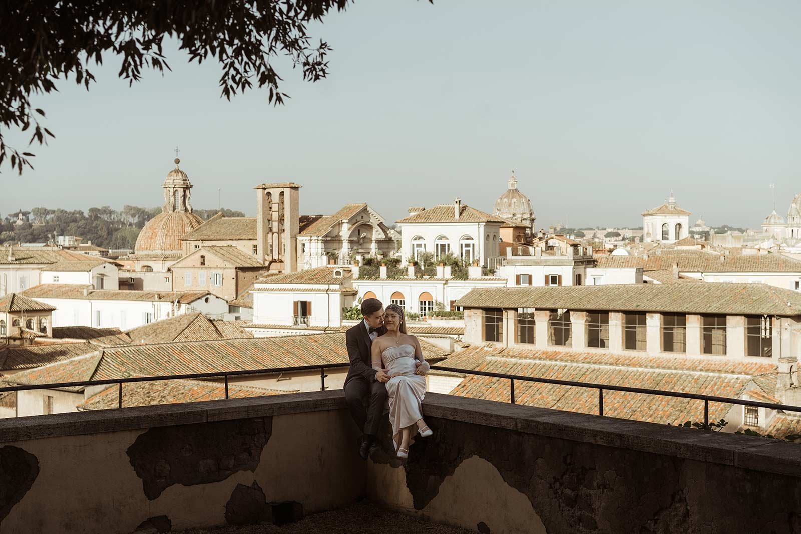 Rome elopement couple embracing on terrace with city skyline view