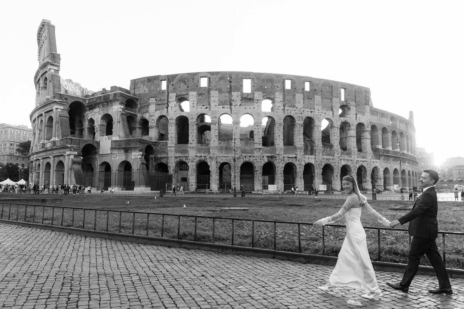 Bride twirling with groom in front of the Colosseum during Rome elopement