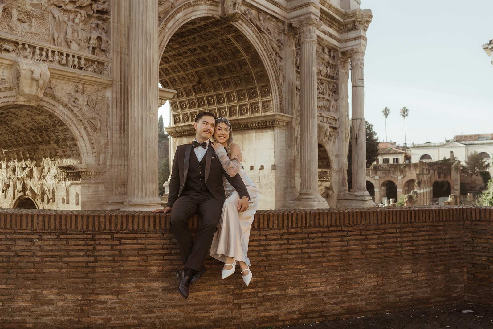 Rome elopement couple smiling in front of the Colosseum