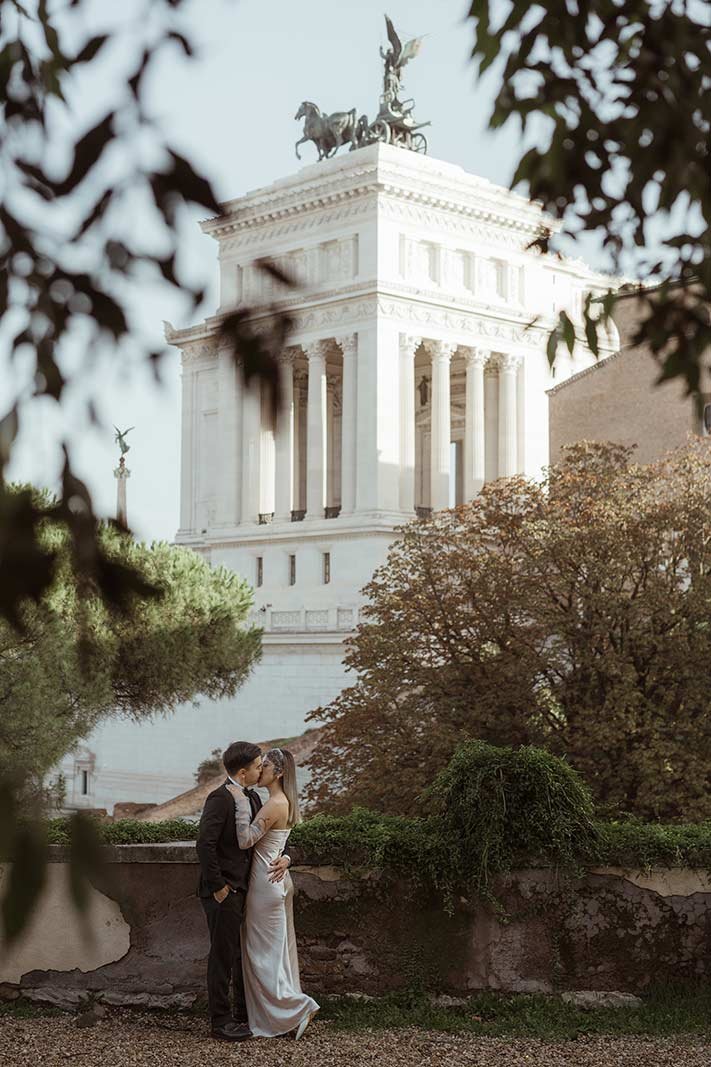 Rome elopement couple embracing with Altare della Patria monument in the background