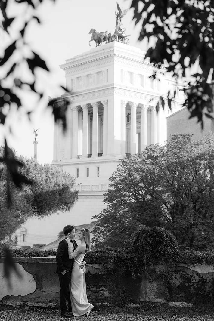 Rome elopement couple embracing with the Altare della Patria monument in the background