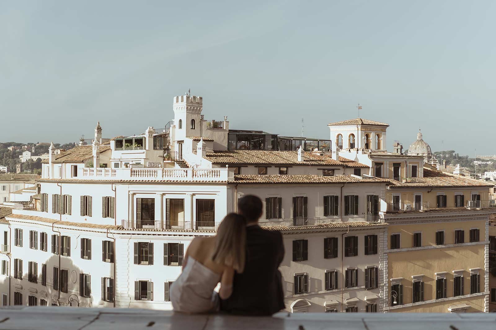 Bride and groom looking at Rome’s rooftops during their elopement