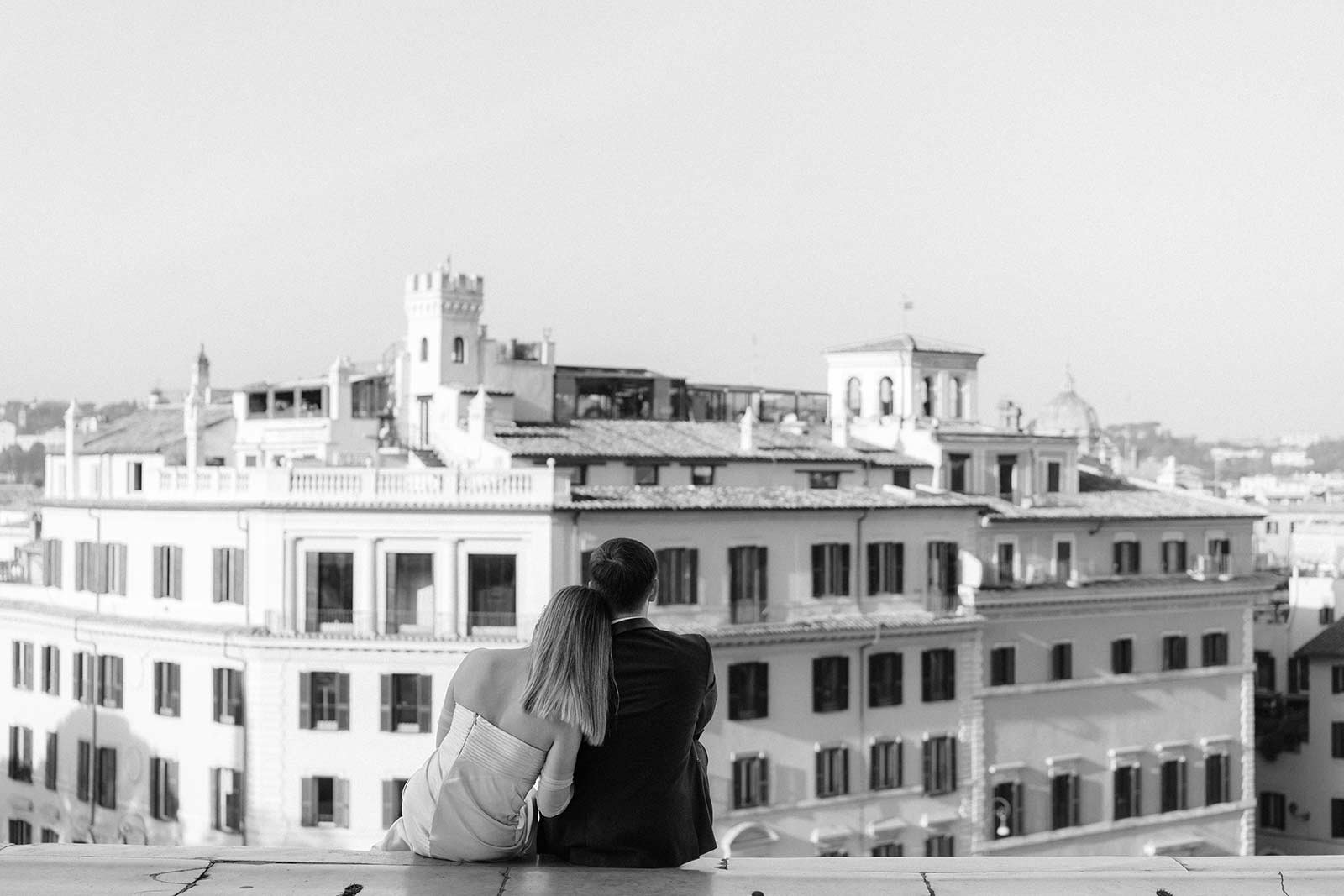 Rome elopement couple embracing with view of Capitoline Hill buildings