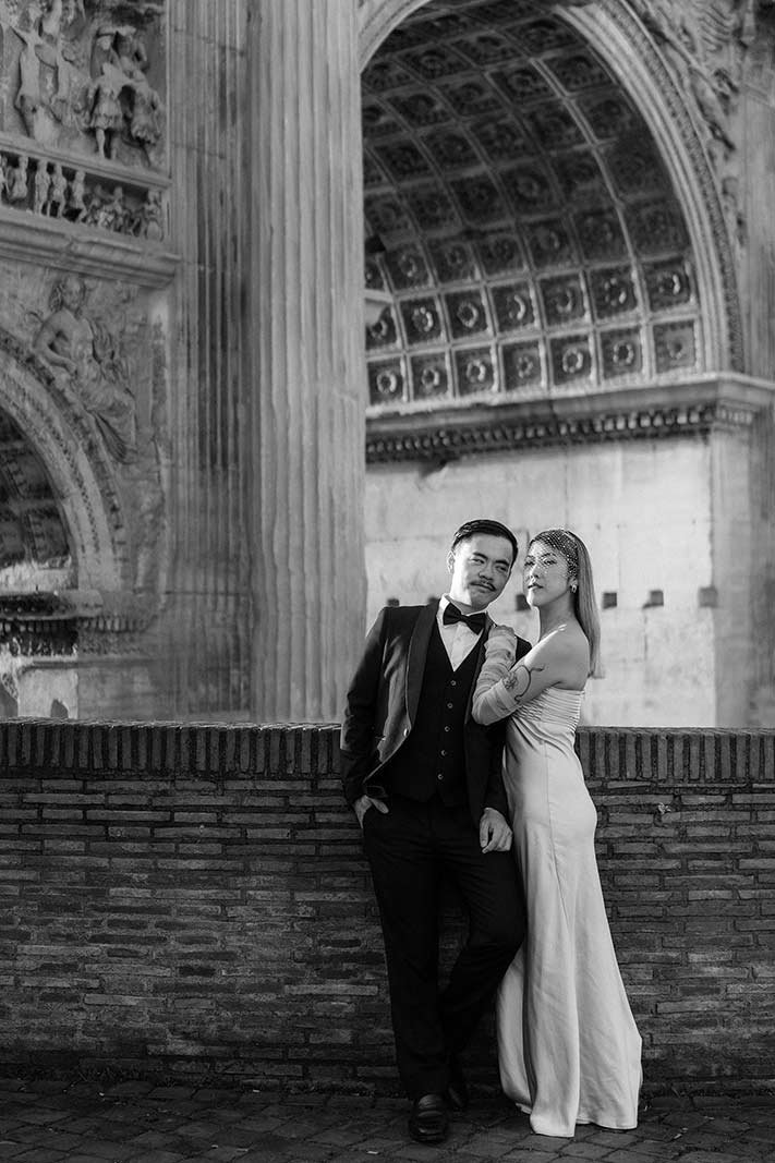 Rome elopement couple posing under the Arch of Septimius Severus