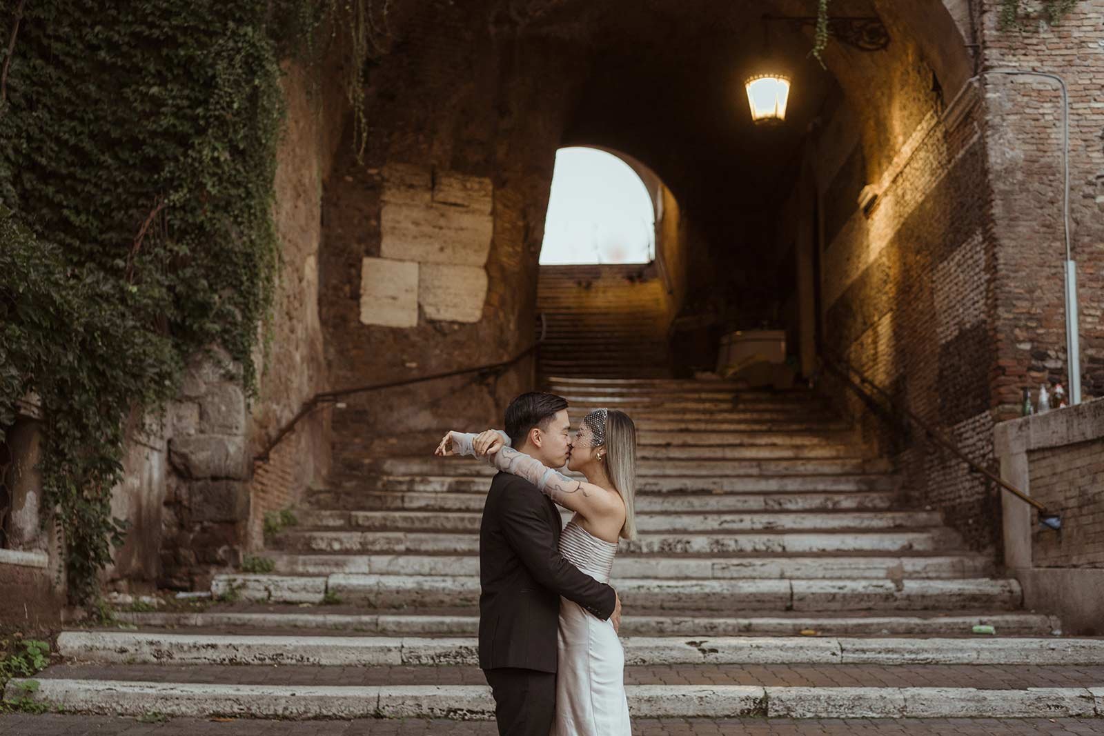 Bride and groom leaning on railing with Roman Forum view
