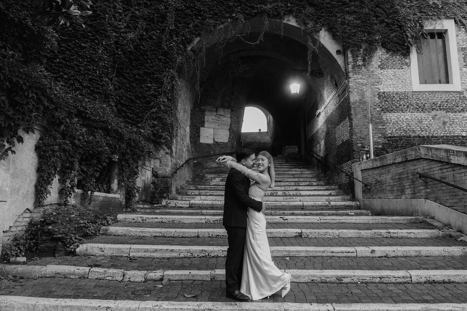 Rome elopement photo of a couple embracing on ancient stone steps