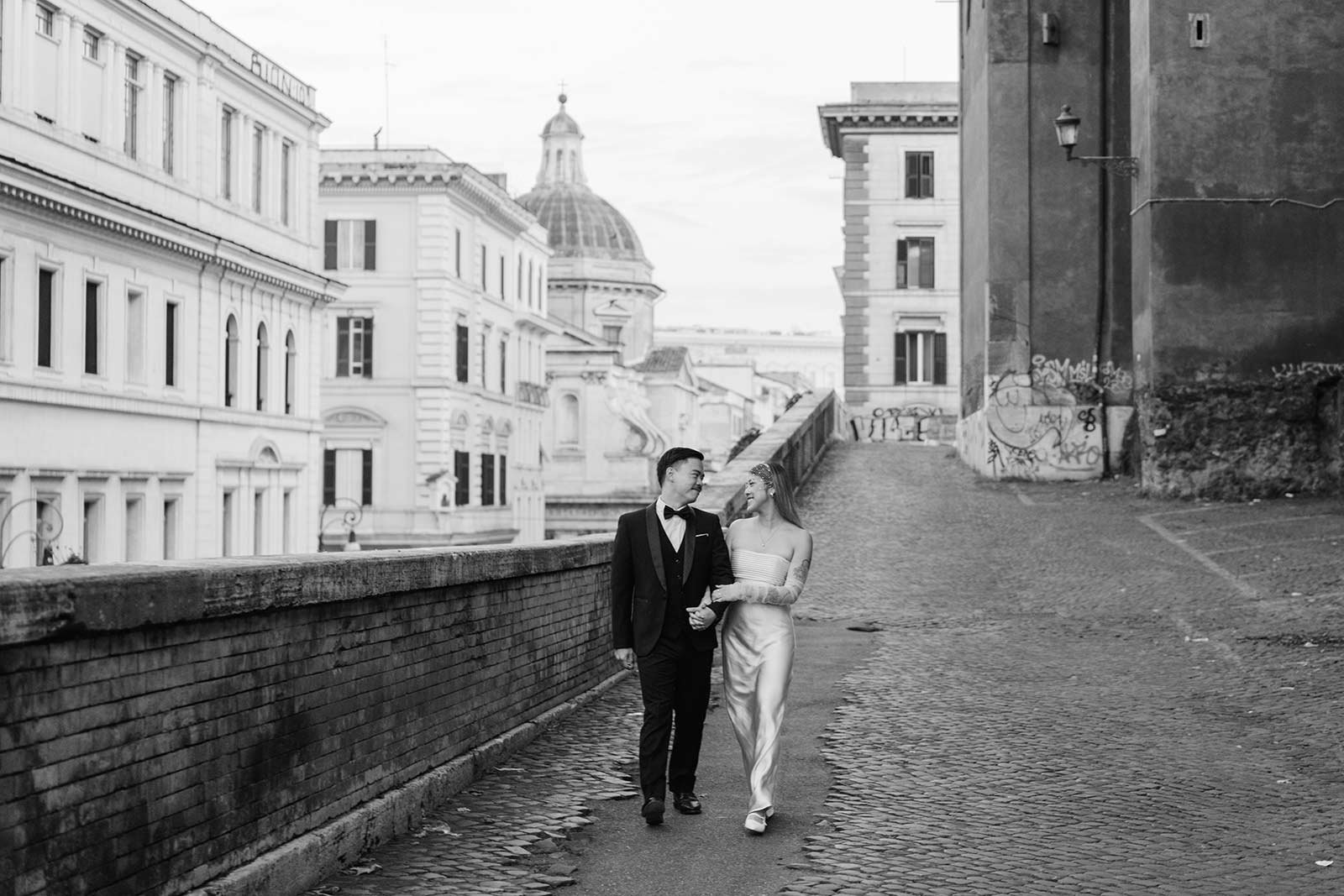 Rome elopement black and white photo of a couple walking hand in hand