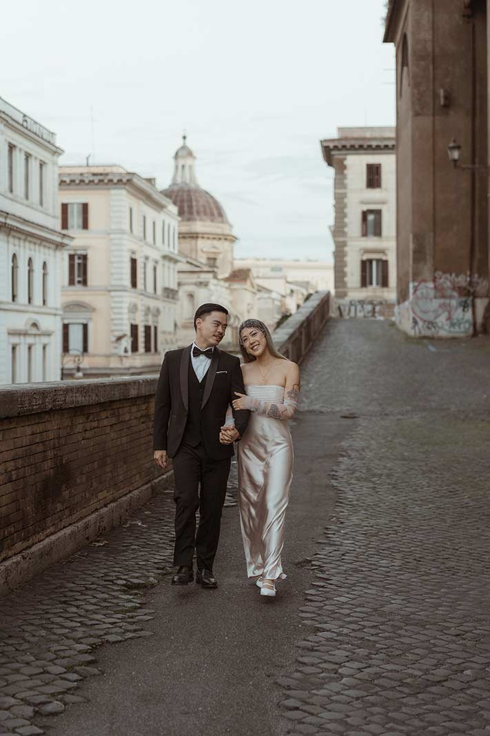 Bride and groom walking together near the Roman Forum in Rome