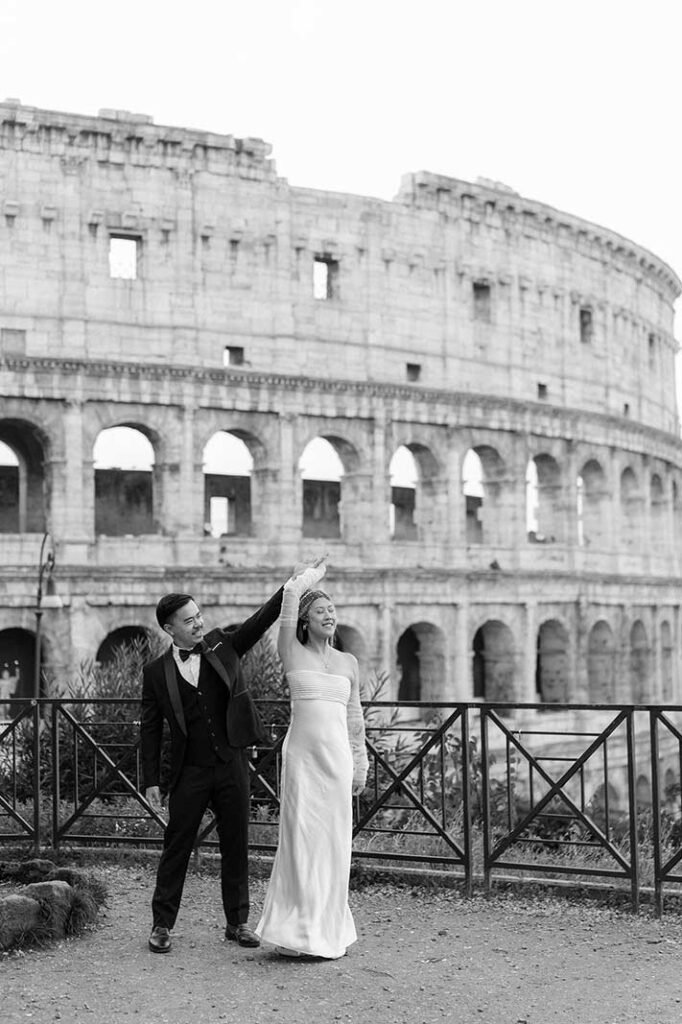 Bride and groom dancing in front of the Colosseum during their Rome elopement