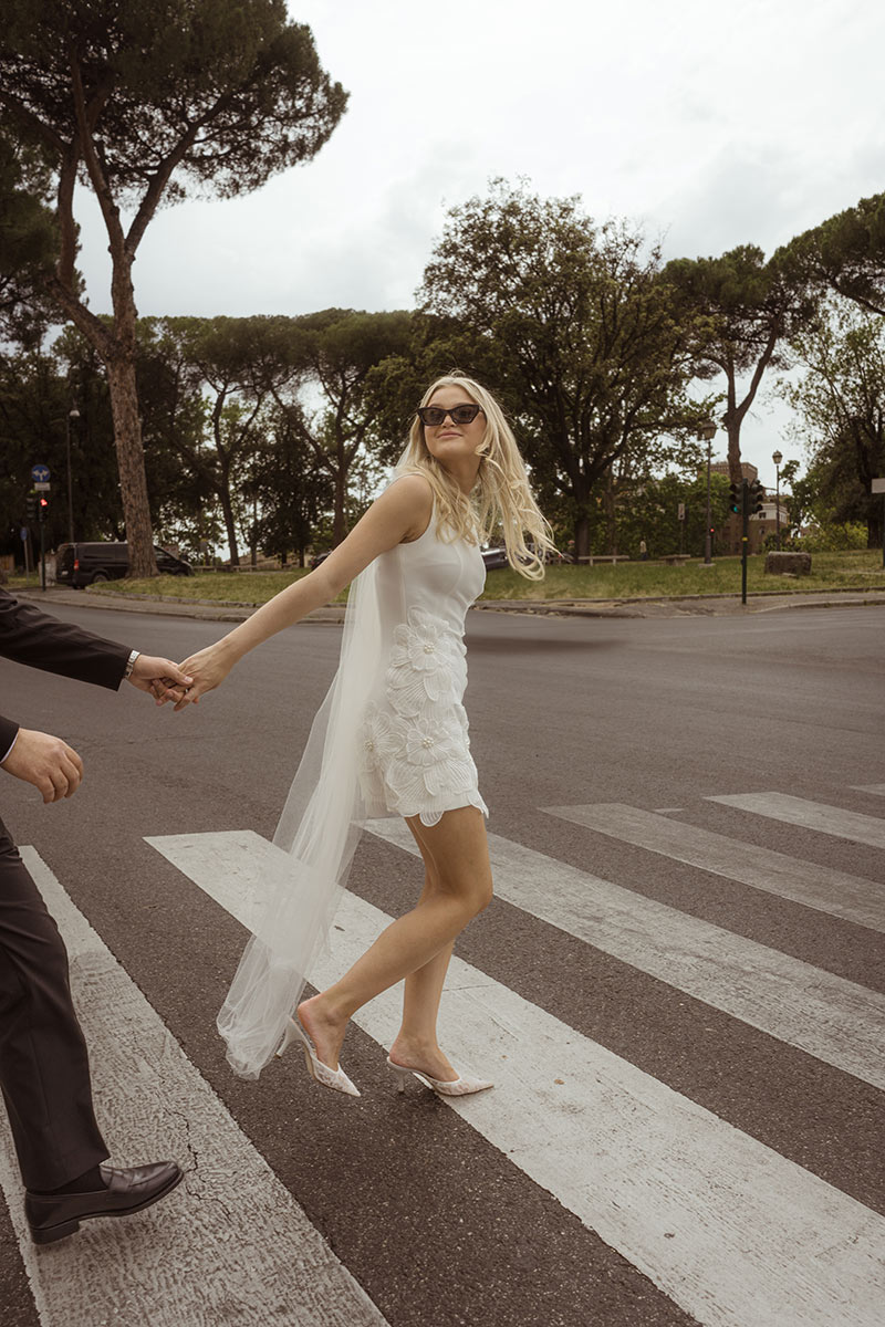 Bride crossing a Rome street — an intentional elopement in Italy