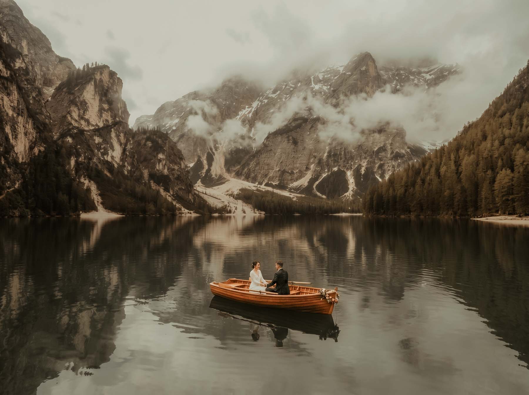 Couple during an intimate elopement at Lake Braies in the Dolomites, Italy.