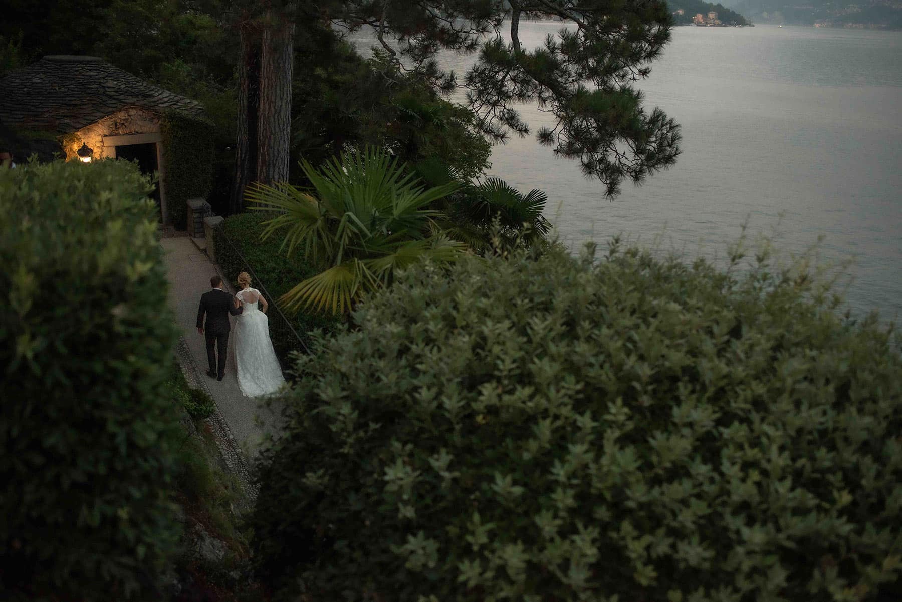 Couple walking through the gardens of Villa Balbianello during an intimate Lake Como elopement in Italy.
