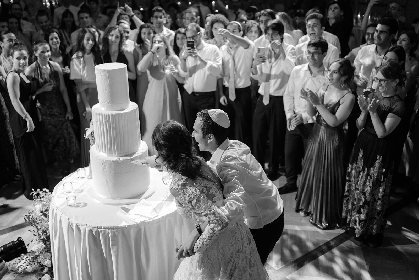 Cake-cutting moment at a traditional wedding celebration